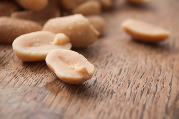 Fototapeta na wymiar closeup of salted peanuts on wooden background