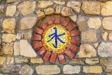 Mosaic religious symbol on wall.