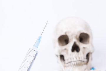 Skull and syringe on white background. Drug abuse, deadly dose of death.
