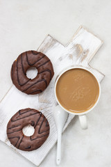 Donuts with chocolate glaze and coffee cup 
