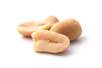 closeup of salted peanuts on white background