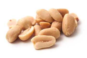 closeup of salted peanuts on white background