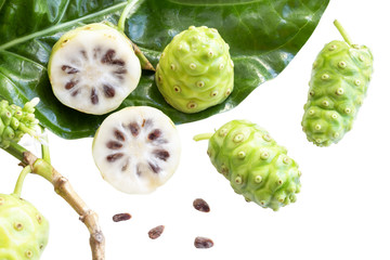 Naklejka na ściany i meble Noni fruit or Morinda Citrifolia and noni slice with seed and green leaves of the noni isolated on white blackground with copy space for text. With clipping path.