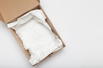 Open cardboard delivery box, fragile beige corrugated.