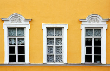 Three windows with curtains