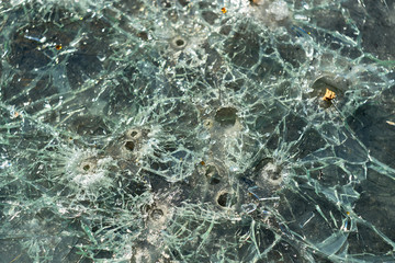glass pierced with bullets