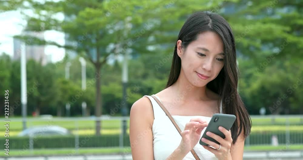 Wall mural woman work on smart phone in city