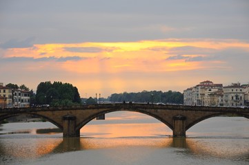 Fototapeta na wymiar Ponte Alla Carraia Bridge at sunset on the Arno River, in Florence, Italy