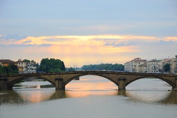 Ponte Alla Carraia Bridge at sunset on the Arno River, in Florence, Italy