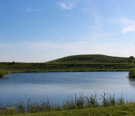 A view of the lake and the hill in the evening sky.