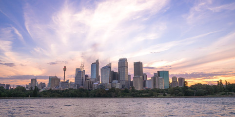 Sydney harbour cityscape at dusk with colourful sunset sky and clouds, the most busiest attractive city in Sydney. 12-01-2018 : Sydney, Australia.