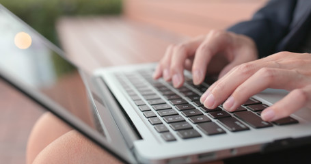 Business woman type on notebook computer
