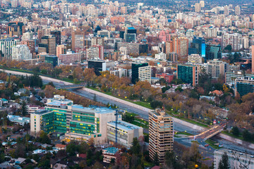 Fototapeta na wymiar Santiago, Metropolitan Region, Chile - June 01, 2013: Panoramic view of Providencia district with Mapocho River and the snowed Andes mountain range in the back.