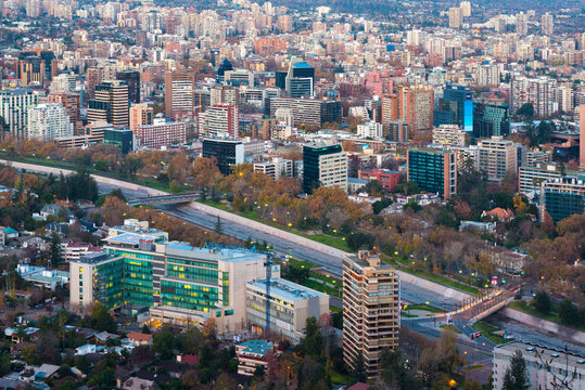 Santiago, Metropolitan Region, Chile - June 01, 2013: Panoramic view of Providencia district with Mapocho River and the snowed Andes mountain range in the back.