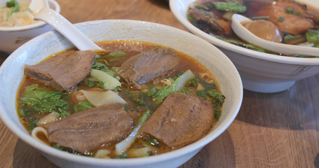 Family enjoy the beef noodles in restaurant