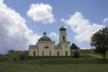 Photo of ancient Khotyn church near the castle in Ukraine at the day time in summer under extremely fluffy clouds