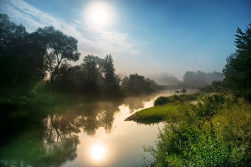 Fototapeta premium Landscape with moon light at night over river. Fog above water and trees
