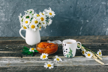 Cup of tea,  flowers, on dark wooden background