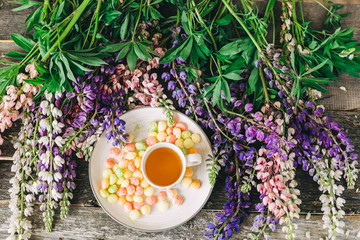 Cup of tea,  flowers, on dark wooden background