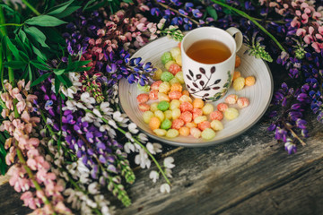 Cup of tea,  flowers, on dark wooden background