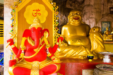 Golden Buddha and red Ganesha in Tiger Cave Temple, Wat Tham Suea in Thailand