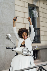 Beautiful girl for afro in the streets of Madrid Spain with motorcycle.