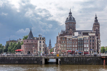 Fototapeta premium Amsterdam canal scene with dramatic sky