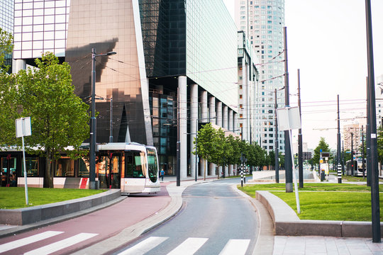 Rotterdam city centre with futuristic buildings and local tram.