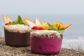 Takeaway acai bowls with fresh fruit and mint