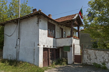 Part of street in the Paunovo village with old house, tree and fence, Sredna Gora mountain, Ihtiman, Bulgaria, Europe