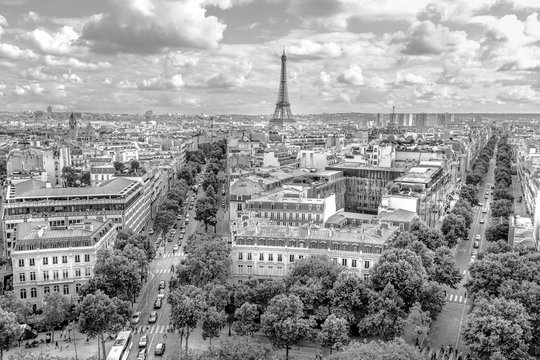 Arch of Triumph panorama in black and white. Trees streets like Avenues Marceau, d'Iena and Kleber in Paris, France, Europe. Distant view of Tour Eiffel tower in Paris cloudy skyline.