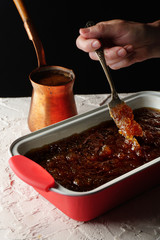 Form with a cold dessert on the table and a coffee maker