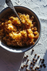 Bowl with a cold coffee dessert and grains on the table closeup