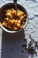 Bowl with a cold coffee dessert and grains on the table