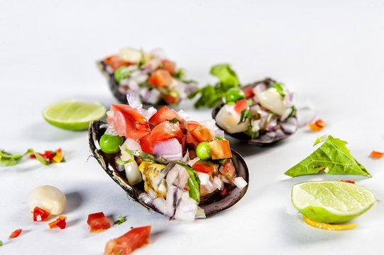 Peruvian style food Scallops a la chalaca.