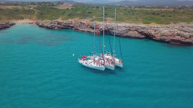 Yacht sailing on open sea at sunny day. Sailing boat in slow motion. Sailing aerial 4k video
