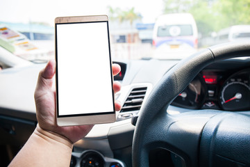 Man driver hand holding and Using smart phone with blank white screen in car.