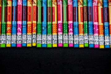 Group of graphite pencils with colored eraser at the end, fullframe multi color of pencils on the black background