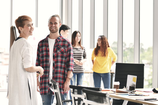 Group of colleagues discussing work in casual setting at office