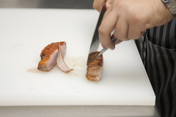 The cook prepares a dish of duck fillet