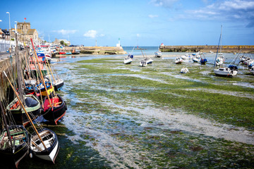 BARFLEUR: Fishing and recreational boats at low tide in the harbor of Barfleur. Barfleur is a...