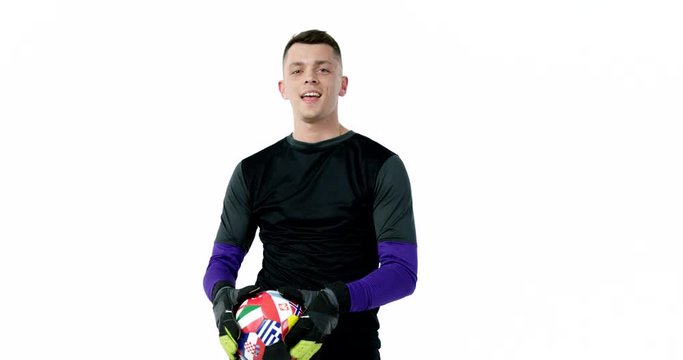 Goalkeeper in sportswear with a ball in his hands dancing