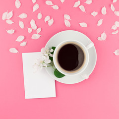 Flat lay of coffee, letter mockup and white petals