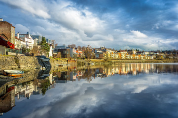 A view of Trondheim reflected in the river. Sunset before the storm. Norway