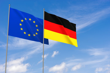 European Union and Germany flags over blue sky background.