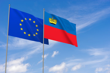 European Union and Liechtenstein flags over blue sky background.