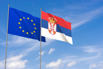 European Union and Serbia flags over blue sky background.