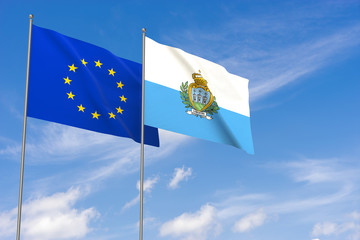 European Union and San Marino flags over blue sky background.