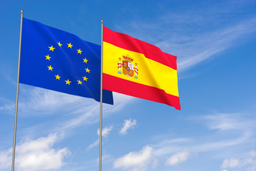 European Union and Spain flags over blue sky background.