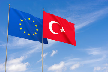 European Union and Turkey flags over blue sky background.
